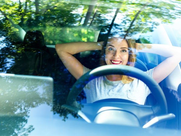 Frau sitzt in einem autonom fahrenden Fahrzeug