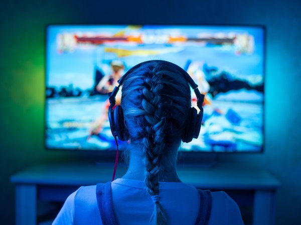 Eine junge Frau spielt ein Computerspiel.
