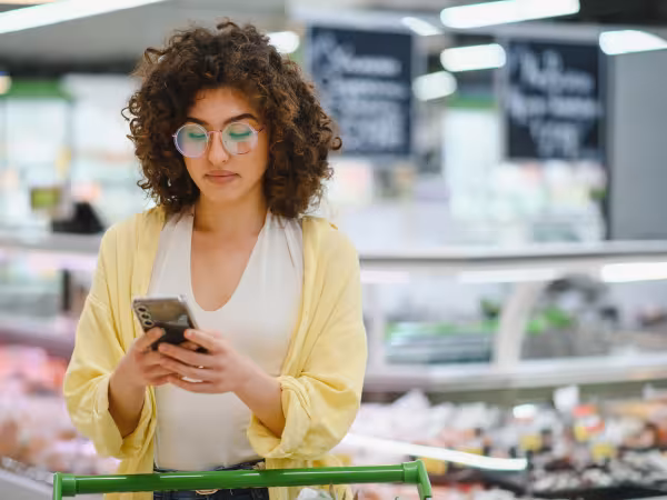 Frau checkt Supermarktapp